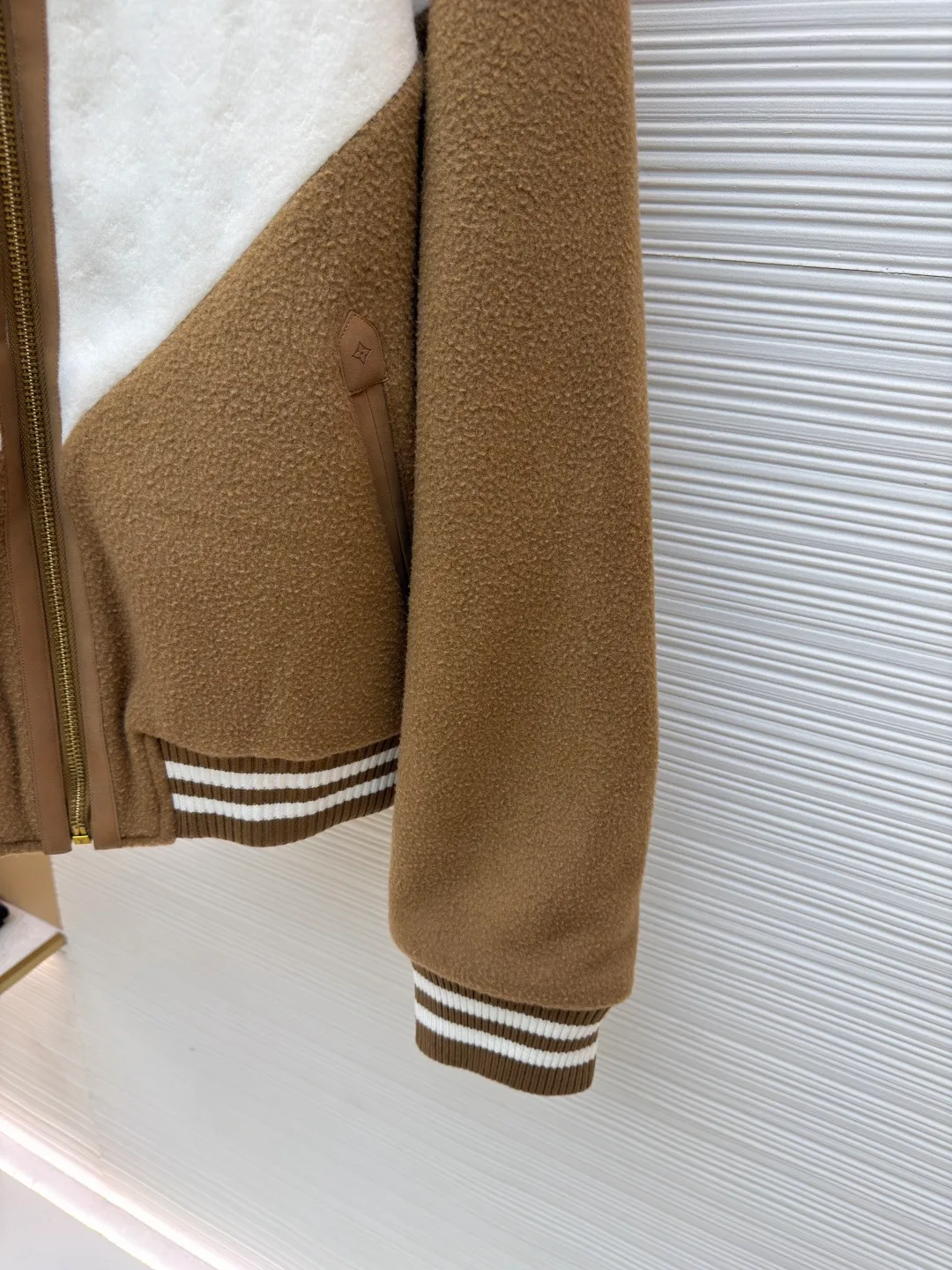 LOUIS VUITTON Shearling collar patchwork jacket ●Original version: 30006 purchase and development ●Item number: 1681987-C25 ●Fabric: wool fabric ●Technology: Positioning cutting machine ●Color: yellow and white ●Version: Fitted version ●Weight: about 1630 grams ●Size: S-M-L-XL ●Description: This sheepskin jacket injects a touch of chic après-ski casual style into your winter look. Featuring a striking 'V' yoke at the front and back, it's made from a blend of sheep's wool and tussah silk and embellished with a Monogram jacquard pattern. The soft shearling collar pulls up to wrap around the neck, while the quilted Monogram pattern on the interior further enhances warmth and comfort. The finishing touch is the LV trim on the chest and refined leather trim on the zippers and pockets. 90% sheep wool, 10% cashmere; Fabric 2: 86% sheep wool, 14% tussah silk; Lining 1: 100% polyester; Lining 2: 100% cotton; Filling: 100% polyester shearling; Cow leather; Except for trim; Contrast yoke with all-over logo jacquard Striped ribbed waist and cuffs The left chest is decorated with metal logo accessories. The quilted logo lining zipper opening and closing has a straight and delicate overall line. The fabric is comfortable and soft, and the color is consistent without color difference. It can be matched with the same style to create a fashionable look and control various occasions. Customized accessories, complete with three labels, same style for men and women!